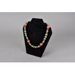 An Art Deco period Chinese bead necklace, made up with white metal, coral, hardwood and soapstone