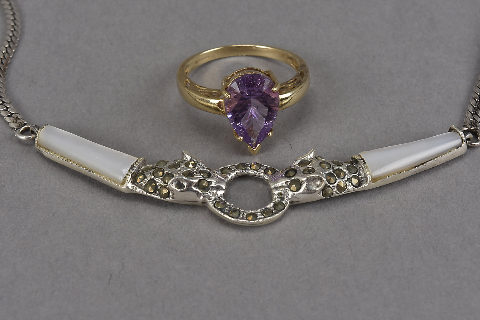 A modern 9ct gold and amethyst solitaire dress ring, together with a silver necklace with