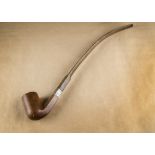 A large antique Briar and elongated vulcanite stem pipe, with silver collar