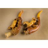 Two carved meerschaum cheroot holders, carved with galloping horses on naturalistic bases, with