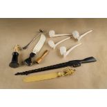 A collection of Boer War pipes and related smoking accessories, including four clay pipes with
