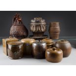 A collection of ten wooden tobacco jars and covers, including one carved from briar with