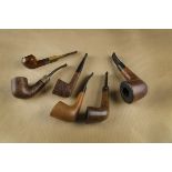 A small collection of British pipes, including a Singleton briar Bullnose, with silver collar for