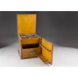 A 19th century light oak and metal mounted pipe cabinet, of square shape, hinged lid with fitted