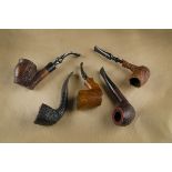A collection of five briar estate pipes, comprising a Bari Wiking, curved shape, rustic square