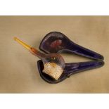A novelty carved meerschaum cased pipe, the bowl carved as a ducks head and beak with glass eyes and