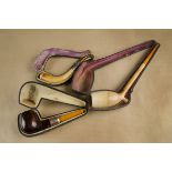 A meerschaum and amber cased pipe, with gold collar in fitted case together with a curved meerschaum