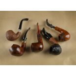 A collection of five briar estate pipes, comprising a Passatore curved pipe with polished flame