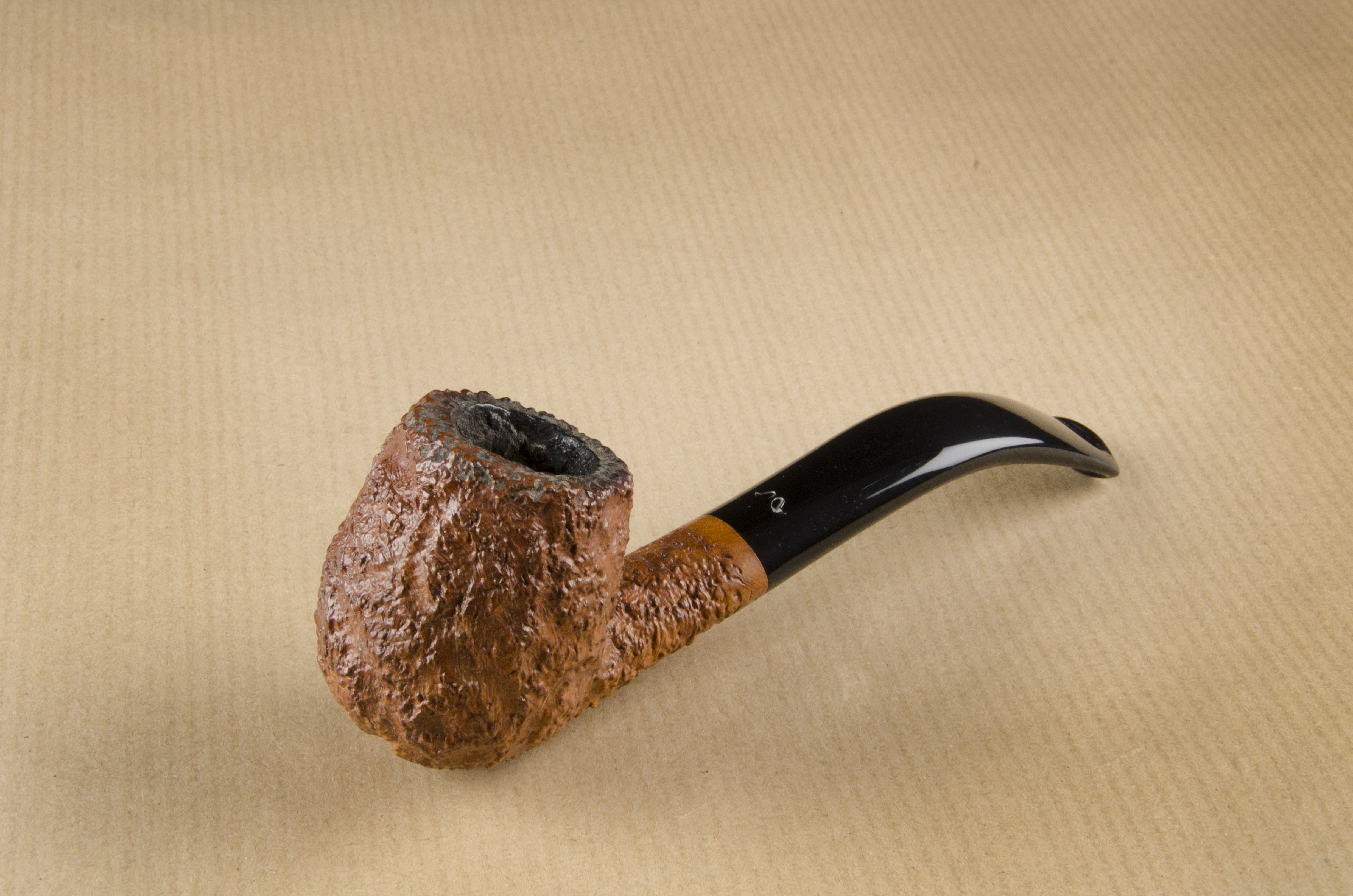 A Caminetto Business briar estate pipe, the rusticated curved bowl and shank, marked to base Hand