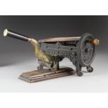 A German cast iron tobacco shedder and cutter, the ornate decorative wheeled base with circular