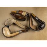 Three cased meerschaum silver collared pipes, with amber mouth pieces, one of straight form with