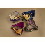 A collection of four mask carved meerschaum cheroot holders, including two with female heads both