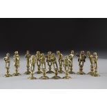 A collection of brass 19th Century pipe tampers, some with match strike bases, all depicting figures