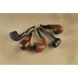 Four Nørding briar pipes, including a polished example with faceted bowl, a squat cushion shaped