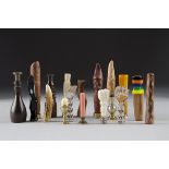 A collection of bone and treen pipe tampers, including figural examples, coral, rosewood, egg cup