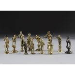 A collection of various brass Dickensian pipe tampers, some on socle bases others on plain oval