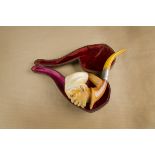A cased Victorian meerschaum pipe, the bowl carved as a North African bearded gentleman wearing
