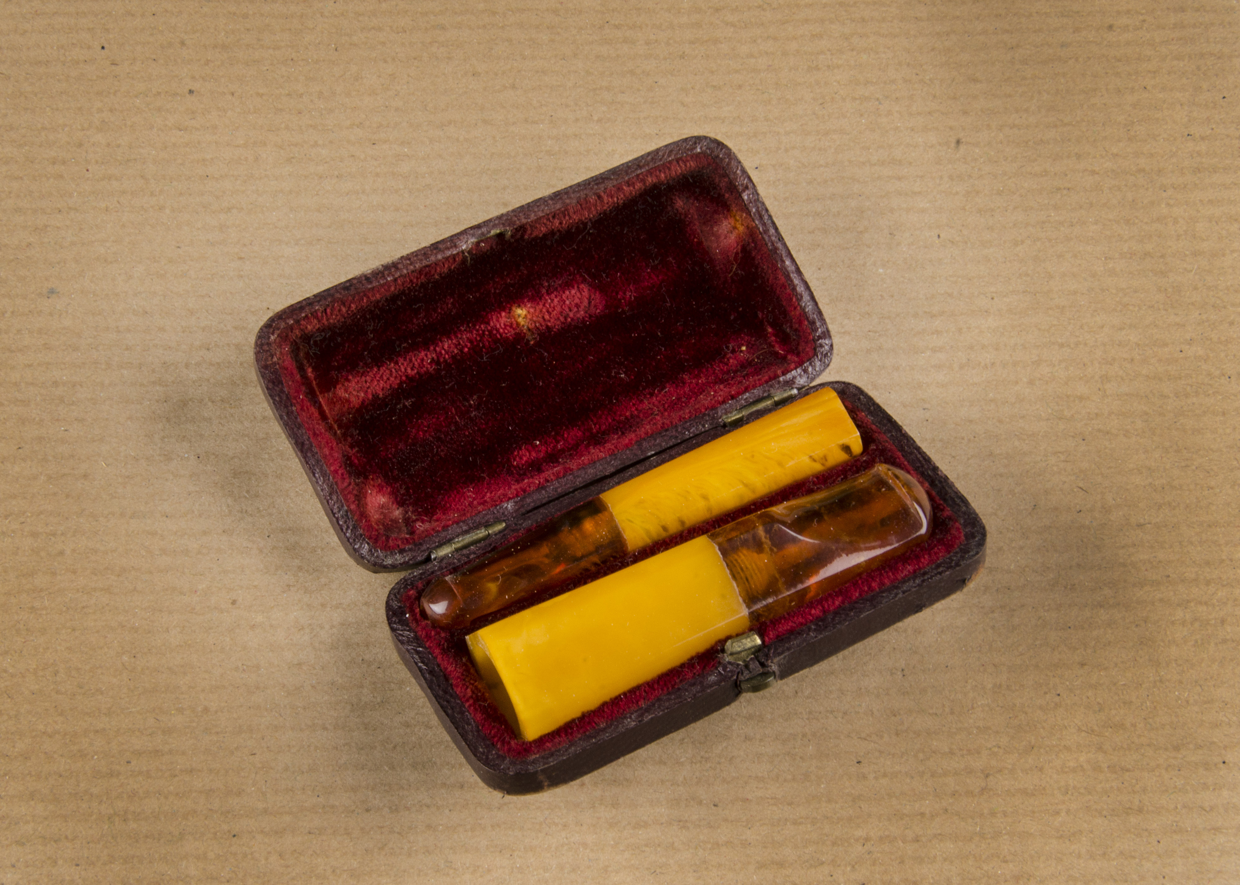 An Art Deco amber cigar and cheroot set, of hexagonal shape, with solid amber holders and Baltic