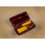 An Art Deco amber cigar and cheroot set, of hexagonal shape, with solid amber holders and Baltic