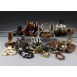 A large collection of metal, leather, ceramic and wooden pipe stands, including some by Dunhill, a