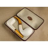 A cased meerschaum pair of pipes, one curved the other straight with plain bowls, gold collars and