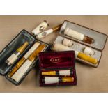 A collection of amber and meerschaum cheroot holders, comprising a pair of cased examples dated