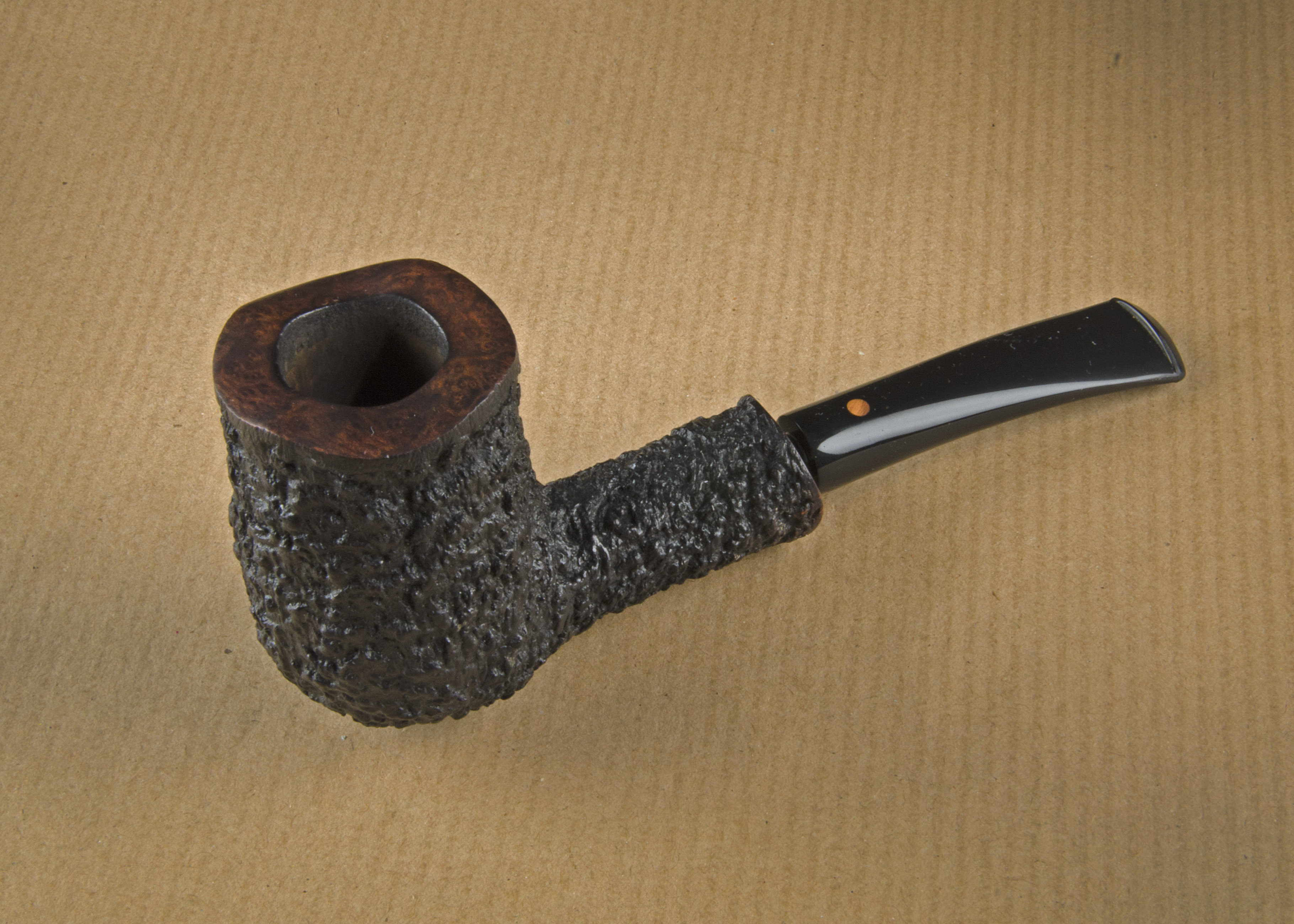 A Weiner briar estate pipe, the rusticated sitter, smooth rim, signed to underside, Weiner 10499