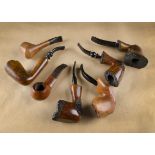 A collection of G.W Sims briar estate pipes, comprising four free hands with sandblasted panels, and