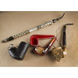 A 19th Century meerschaum and silver leather cased pipe, having ornate mother of pearl and horn stem