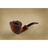 A Daniel Jud briar estate pipe, the sandblasted bowl with rusticated rim, curved stem, marked to