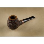 An Amorelli, Roccella briar estate pipe, the rusticated sitter, with 18K marked band to shank and