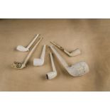 Six interesting white clay pipes, all with decorative bowls, including Crystal Palace of large