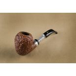 A Pier Luigi briar and chrome unsmoked pipe, of curved shape, with rusticated bowl, marked Fatta a
