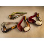 Four cased Meerschaum pipes, each with plain bowls, white metal collars and amber mouth pieces,