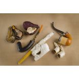 A collection of modern and antique meerschaum pipes, comprising a modern example carved with a