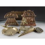 Two copper art nouveau hanging pipe racks, a pair of brass hanging conical spill holders, a
