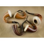 A collection of four Calabash gourd and meerschaum estate pipes, together with a carved example with