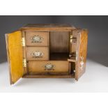 A late 19th century pipe cabinet, of rectangular shape, with hinged panel doors with three fitted