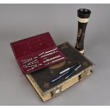 A collection of drawing and writing instruments, including a Parker fountain pen, a Sheaffer example