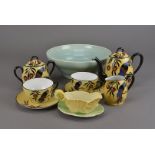 A Limoges porcelain art deco tete a tete tea service, having parrot and orange decoration to