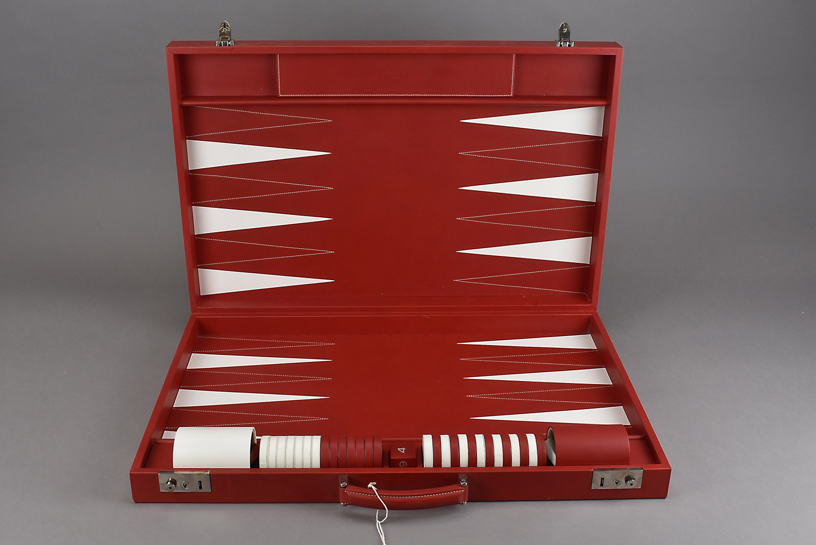 A red leather cased Asprey backgammon board, with leather counters and numbered die, marked Asprey