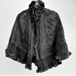 A collection of 19th century clothing, including two shawl or capes, a pair of open drawers, a