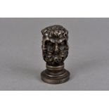 A 19th Century continental desk seal, the handle decorated with classical heads interlinked,