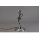 A chromed art deco lamp base, modelled as flapper girl with arm raised, the other to hip on a