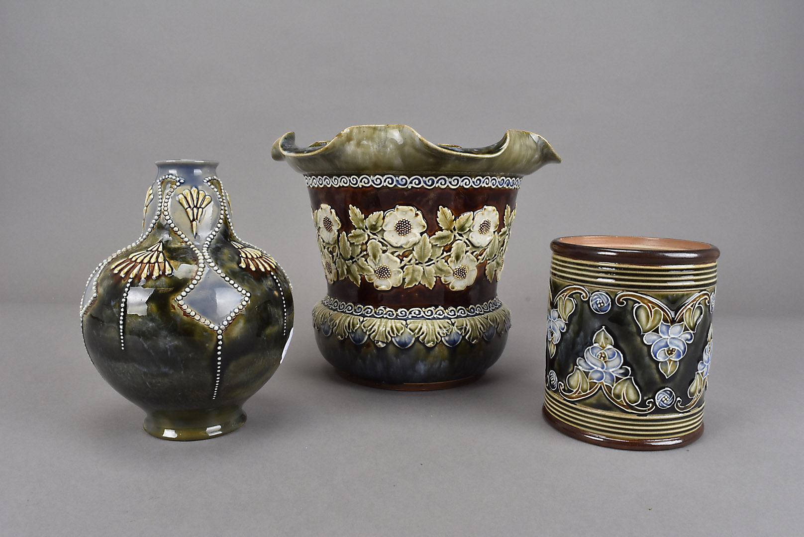 Three pieces of Royal Doulton secessionist ware, including a jardinière and a tobacco jar marked