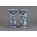 A pair of 19th Century Dutch Delft octagonal vases, the bulbous base supporting a tapered body and