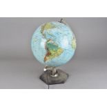 A modern illuminating globe, the globe pivoting on stand, approx. 43 cm H