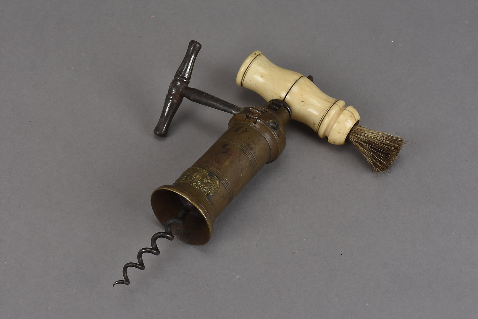 A 19th Century Dowler style Patent corkscrew, with steel ratchet, bone handle with brush and brass