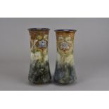 A pair of Royal Doulton stoneware trumpet vases, the upper section decorated with stylised blue