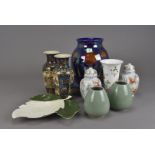 A collection of Poole pottery, including a kite shaped hand painted floral plate, a 1950s cucumber